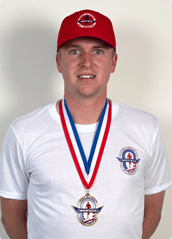NHSTFXCCA All-American shirt, red cap and medal shown on a model