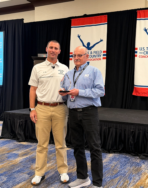 Wayne Clark receiving the 2025 NHSTFXCCA Coaches Hall of Fame award